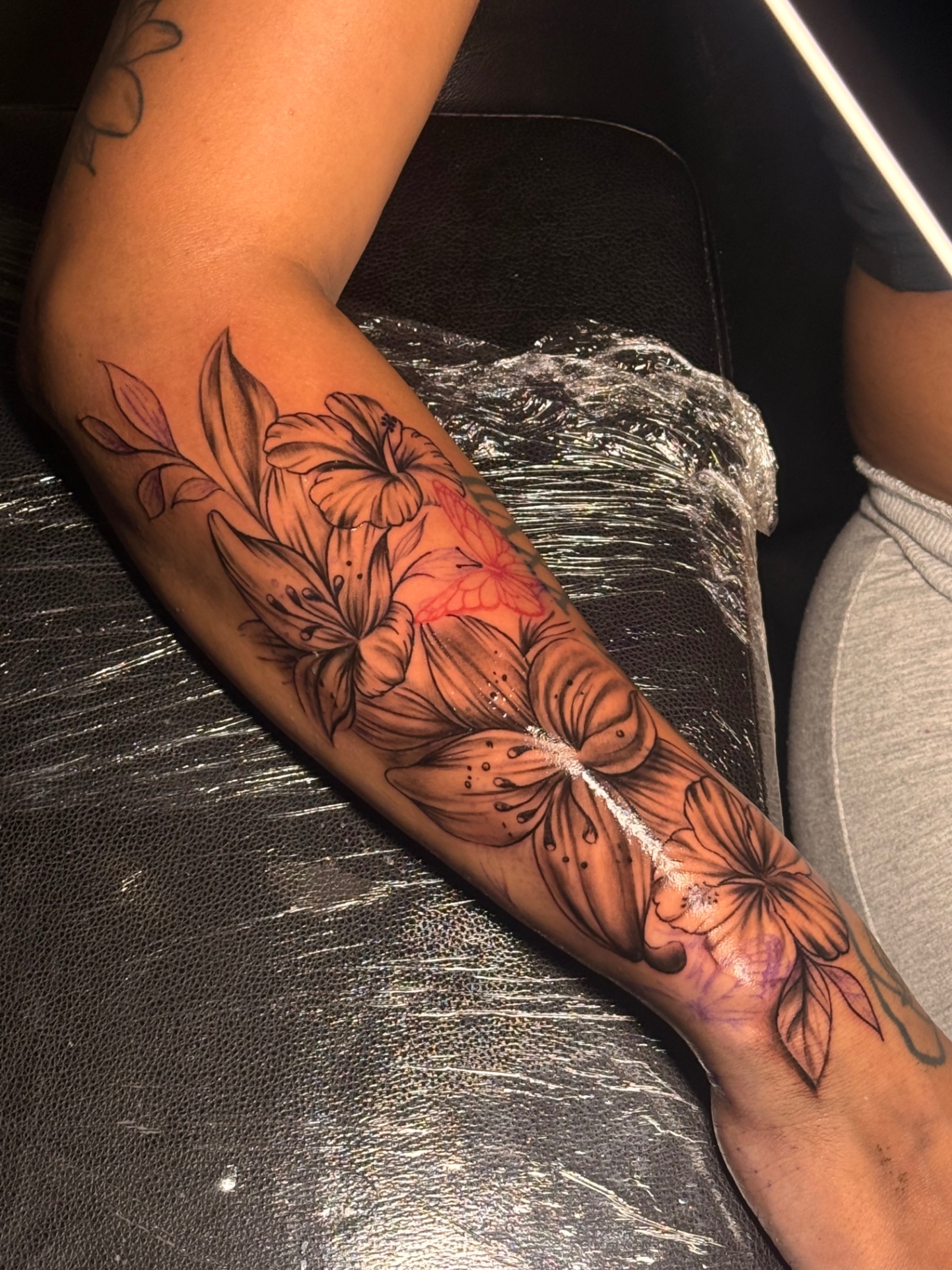 Floral and butterfly forearm tattoo