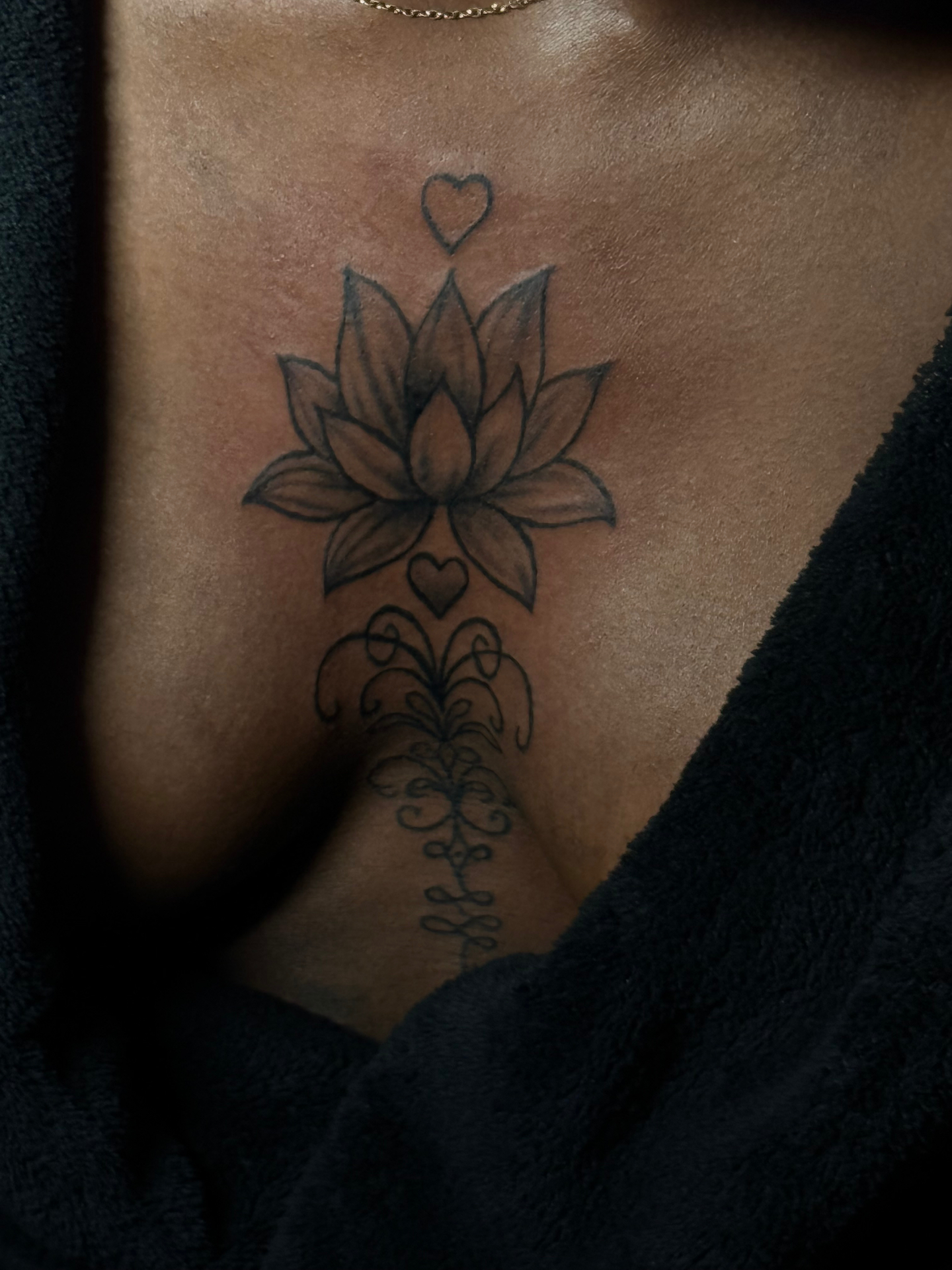 Lotus flower and ornamental sternum tattoo